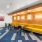chairs and tables along a lighted wall in clubroom